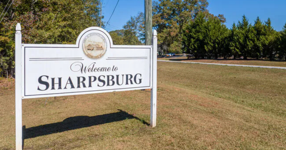Irrigation technician repairing a sprinkler head in Sharpsburg